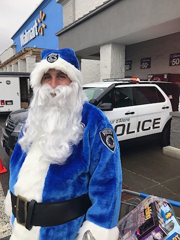 Courtesy of Mario Rios/CDA PD
Sgt. Shane Avriett of the Coeur d&#146;Alene Police Department gave Kris Kringle a breather Monday as he got decked out in Santa&#146;s seldom-used police blue uniform to deliver gifts to hospitalized children. Avriett and the rest of the Coeur d&#146;Alene Police Department will deliver gifts to children at Kootenai Health&#146;s pediatric wing on Christmas Day.