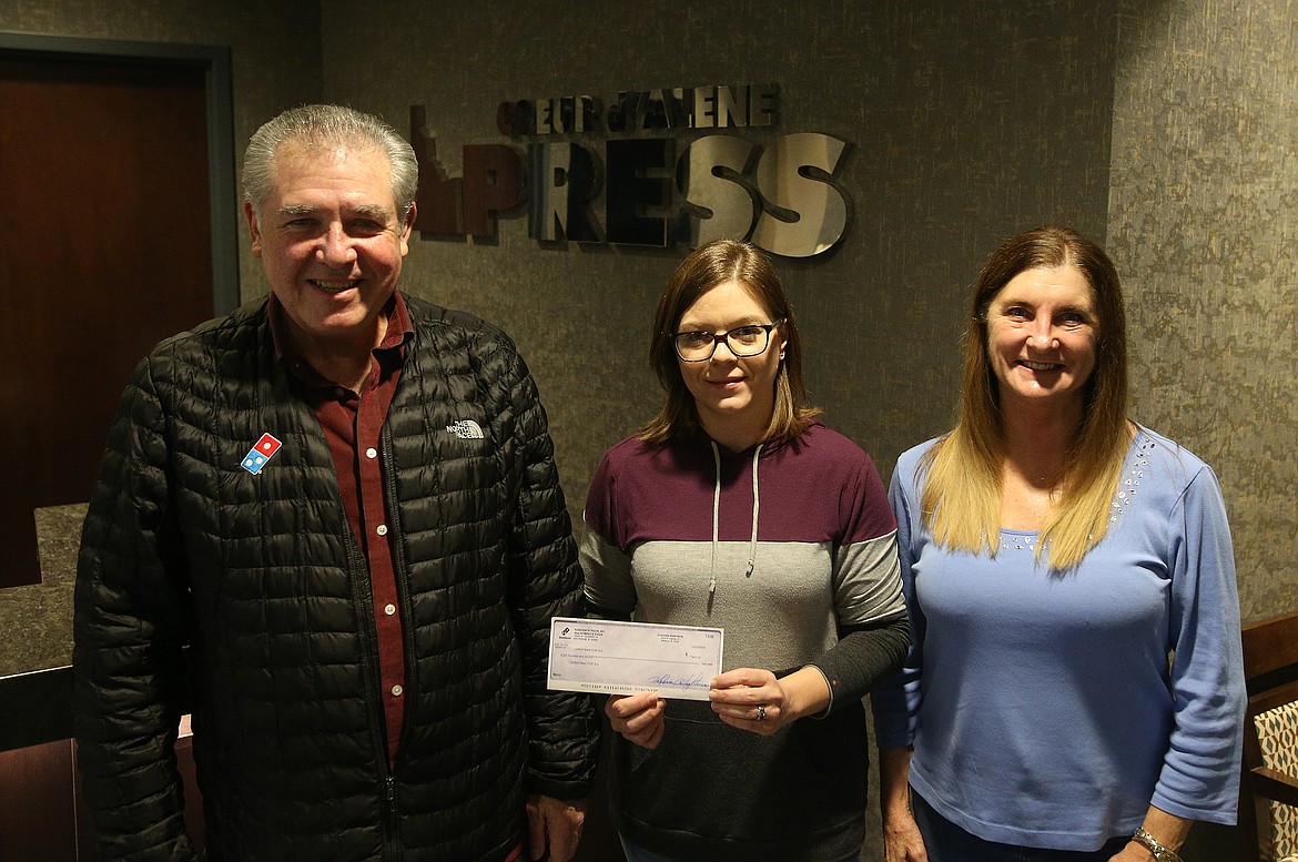 Jim and Melissa Hightower, owners of Domino&#146;s Pizza, and their employees donate $800 to Press Christmas For All.  Holly Paszczynska of The Press accepts the donation. 
LOREN BENOIT/Press