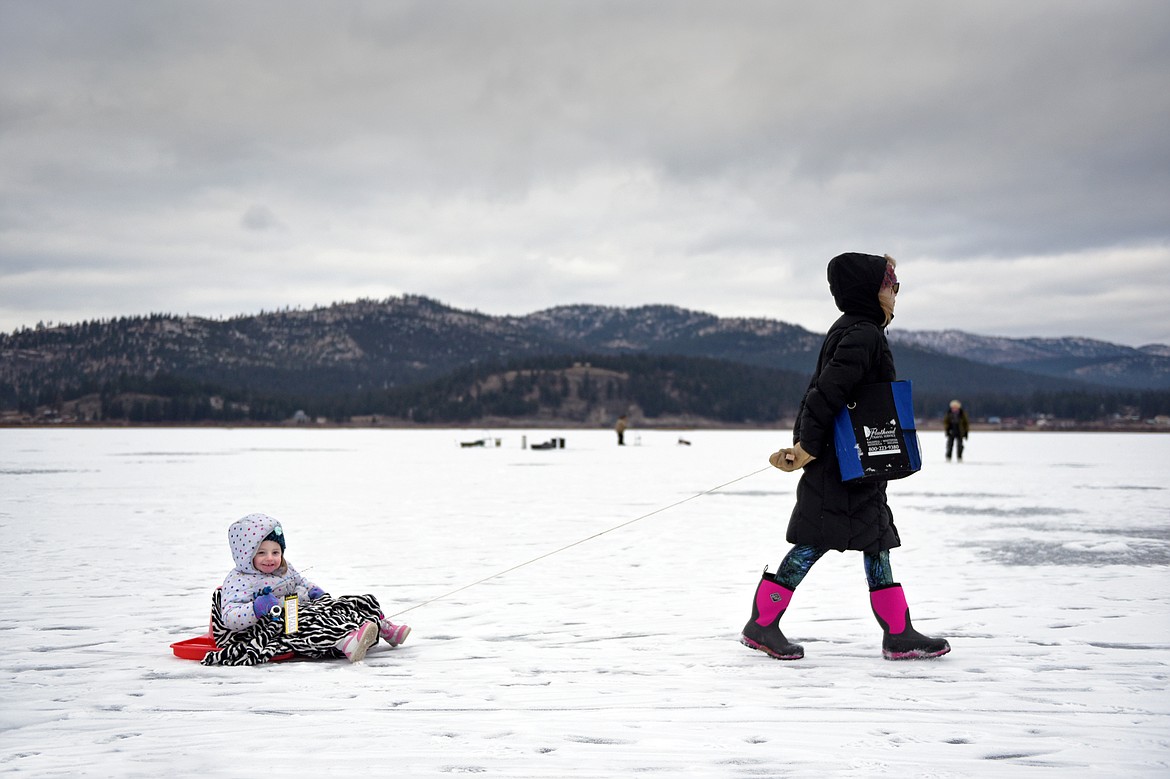 Becky Powell pulls her granddaughter Estella around Smith Lake at the 49th annual Sunriser Lions ice fishing derby on Saturday.  (Casey Kreider/Daily Inter Lake)