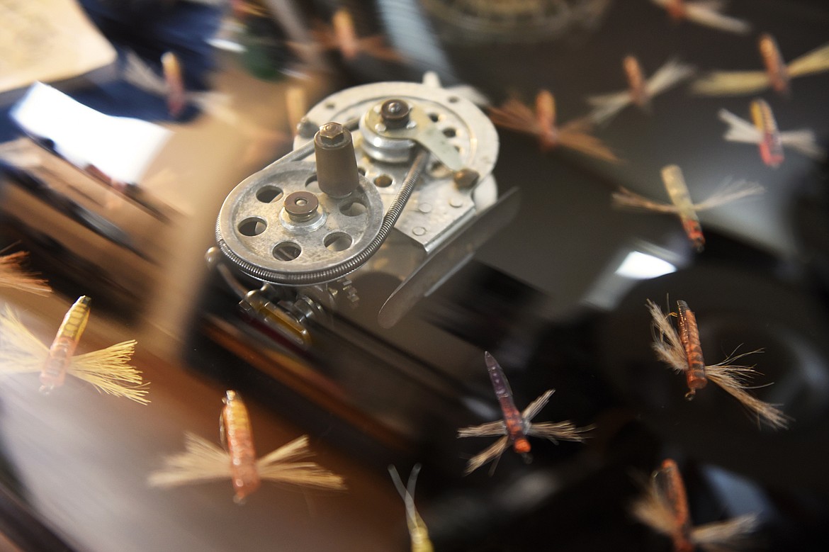 A Kitchen reel, one of the first flywheels ever patented that dates back to 1860, is surrounded by vintage flies called Bunyan Bugs in a display case at True Water Fly Shop in Kalispell on Tuesday, Dec. 24. Bunyan Bugs were designed in the early 1940s by Missoula resident Norman Means and were featured in the 1992 movie &#147;A River Runs Through It.&#148; (Casey Kreider/Daily Inter Lake)