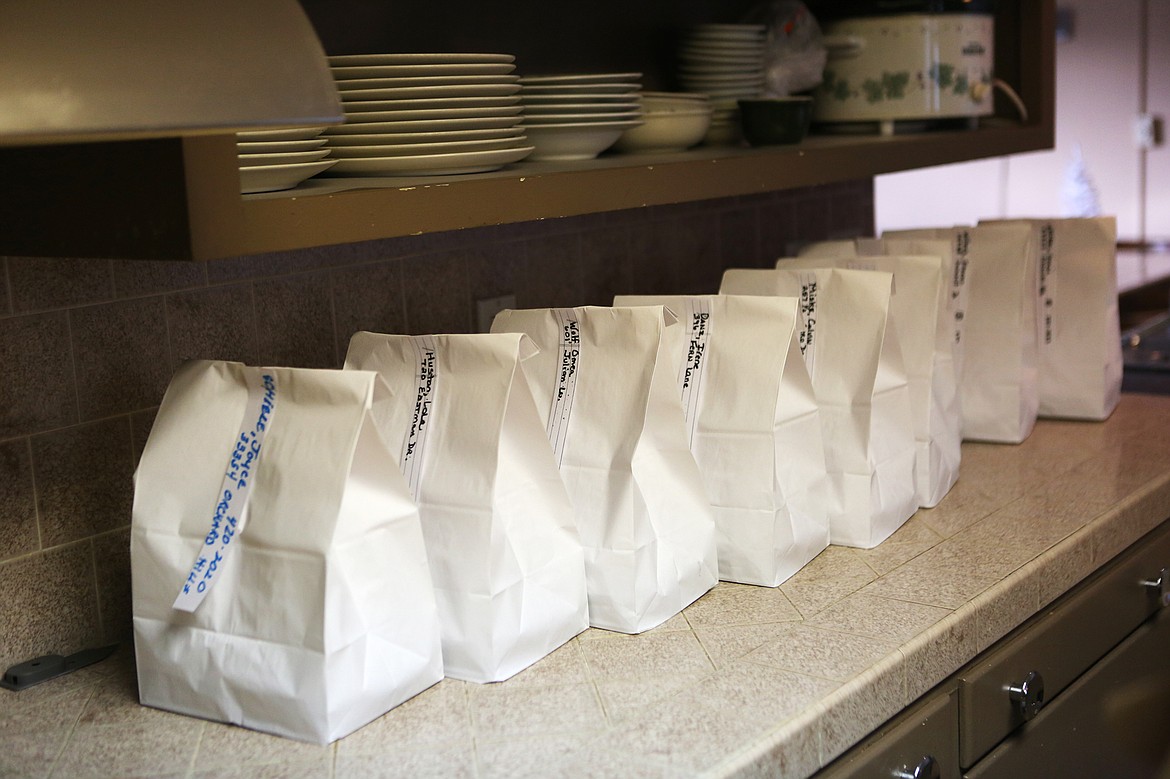 Sacks of food line the counter at the Bigfork Community Center.