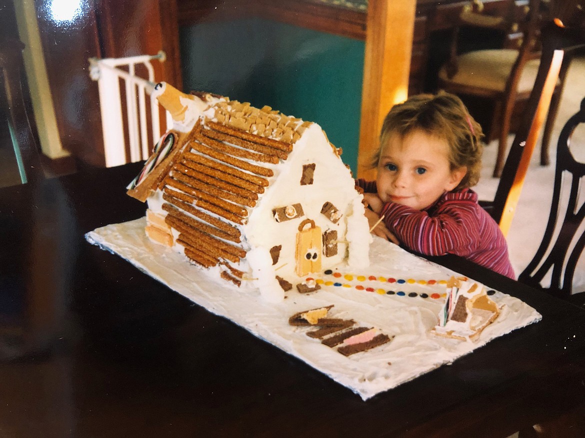 Bret Serbin poses proudly with a gingerbread house.