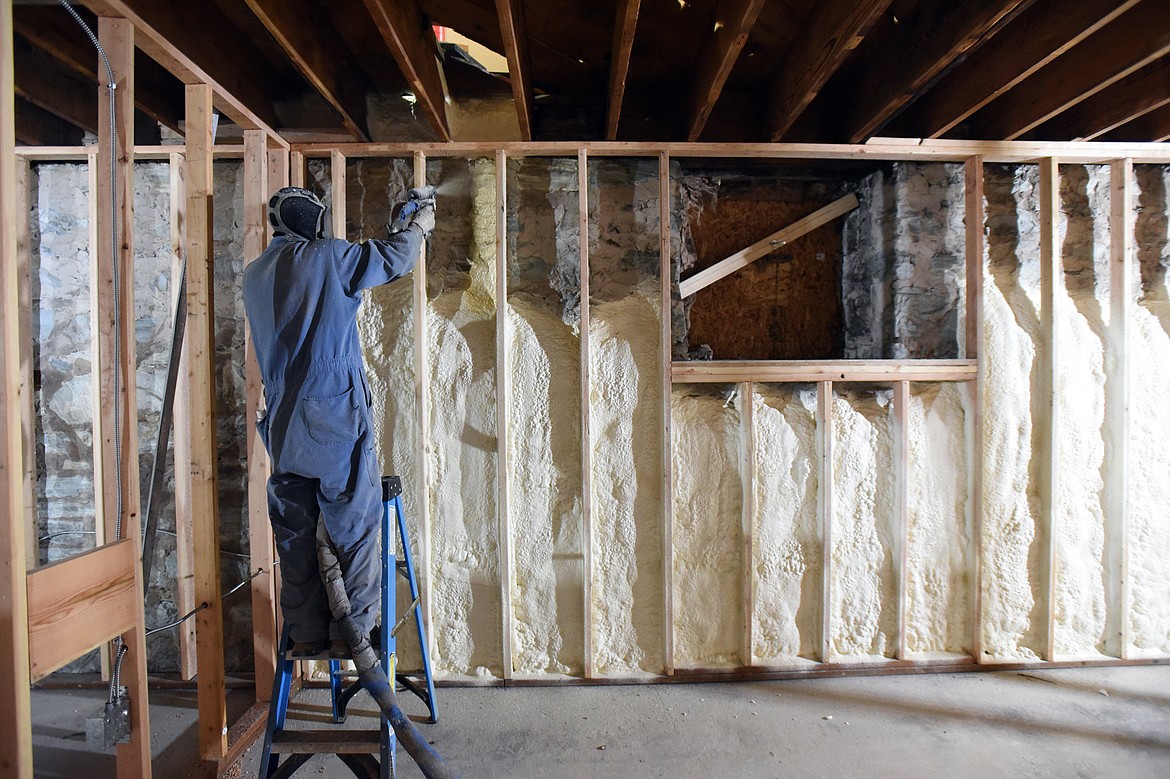 A worker with Lilienthal Insulation applies insulation to the basement walls inside St. Matthew&#146;s Catholic Church in Kalispell on Tuesday, Dec. 10. (Casey Kreider/Daily Inter Lake)