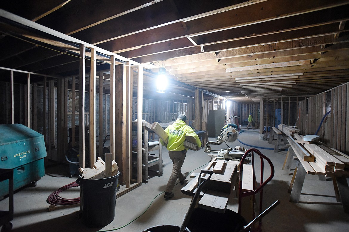 A worker with Swank Enterprises carries materials through the basement of St. Matthew&#146;s. The basement was gutted after being damaged by a fire that started in the kitchen on May 12.