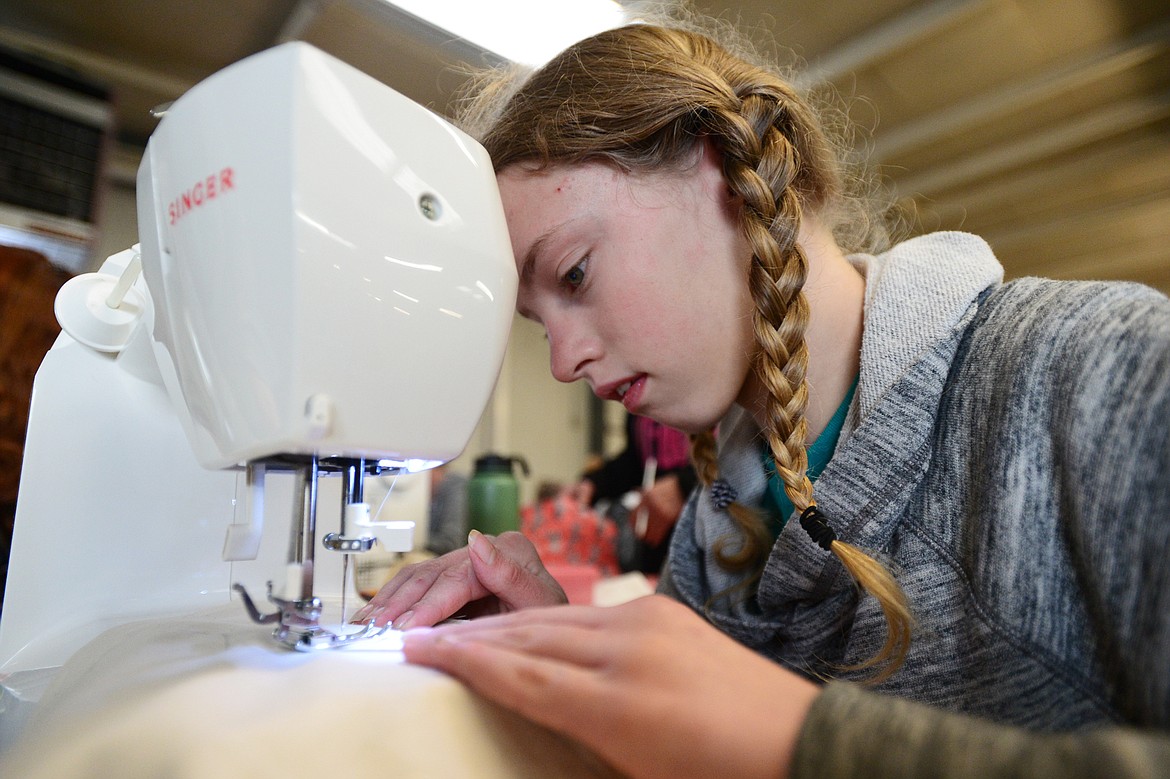 Lux Bain, 12, of Coram, works on the stitching of a medical play doll during a 4-H Sew for Children program at the Country Kitchen building at the Flathead County Fairgrounds on Saturday, Dec. 14. The medical play dolls will be donated to Montana Children&#146;s of Kalispell Regional Healthcare to be used as a teaching tool to help explain medical procedures to patients. (Casey Kreider/Daily Inter Lake)