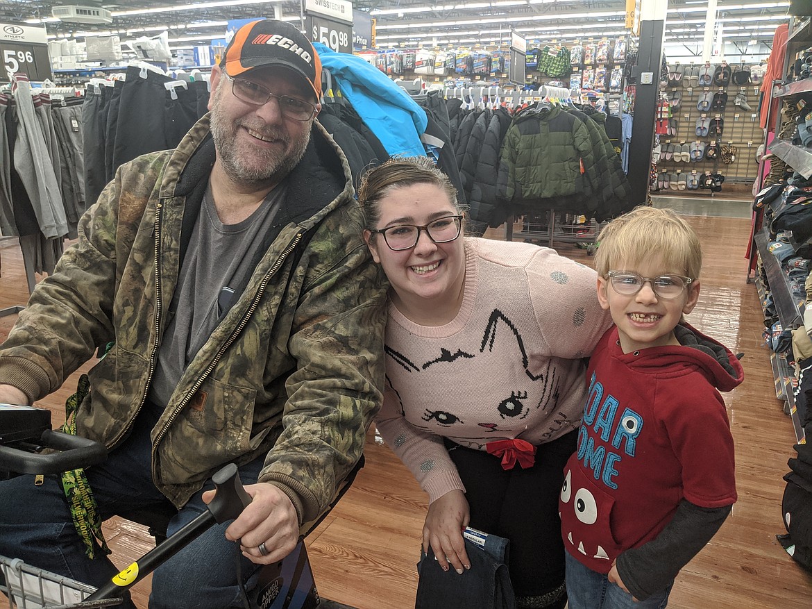 Photo by CHANSE WATSON/ 
Civil clerk Kattie Ross (Center) also helps out the White family with shopping.