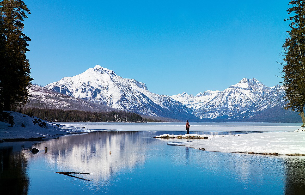 A man looks over Lake McDonald.