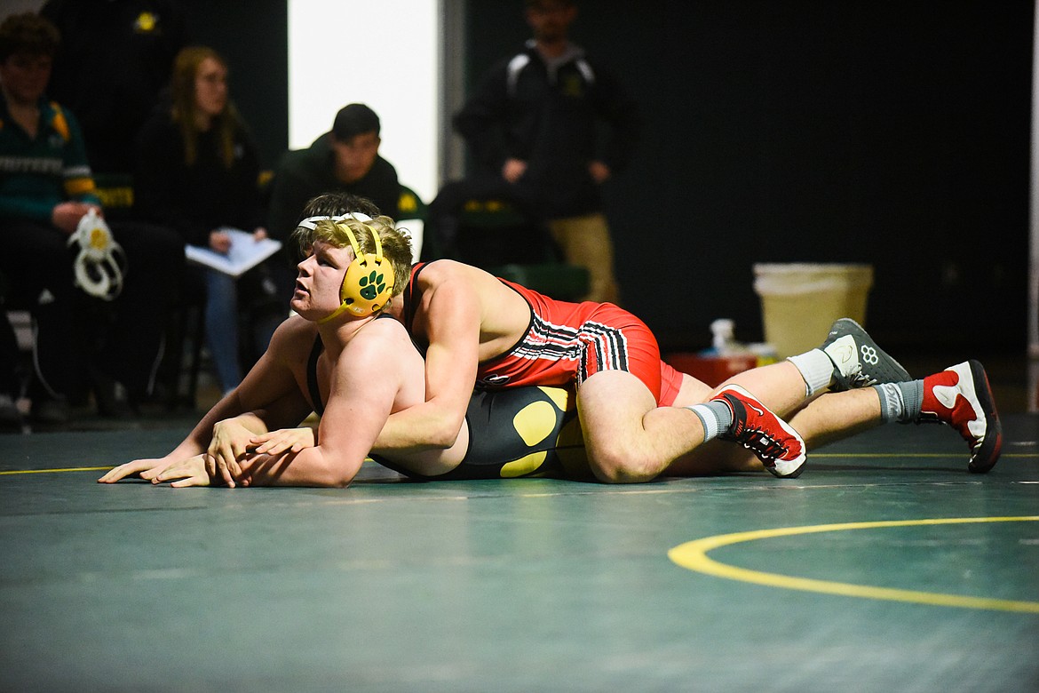 Ashton Akey fights off a Browning wrestler at a home triangular last Tuesday. (Daniel McKay/Whitefish Pilot)