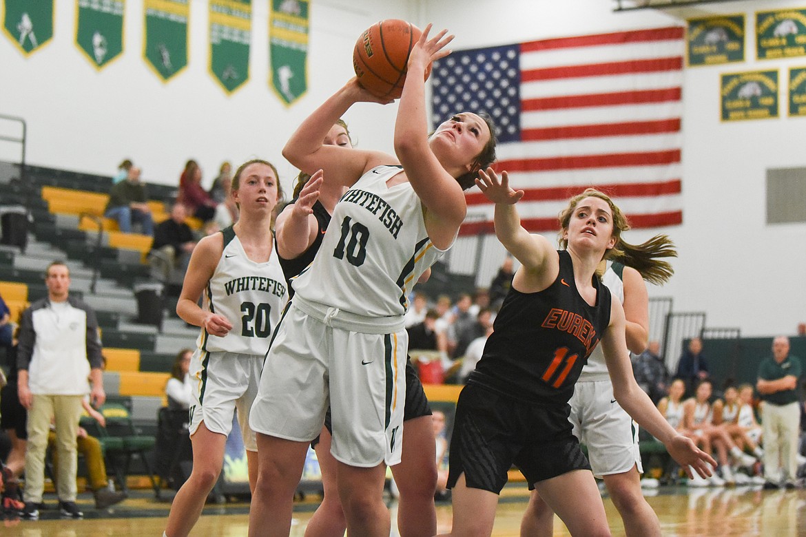 Bulldog Kali Brubaker fights through contact during Thursday&#146;s game against Eureka. (Daniel McKay/Whitefish Pilot)