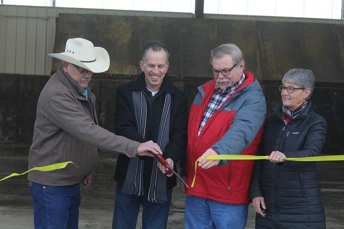 CUTTING THE ribbon are Glen Magera, Tony Cox, Lyle Coney and Carol Brooker.