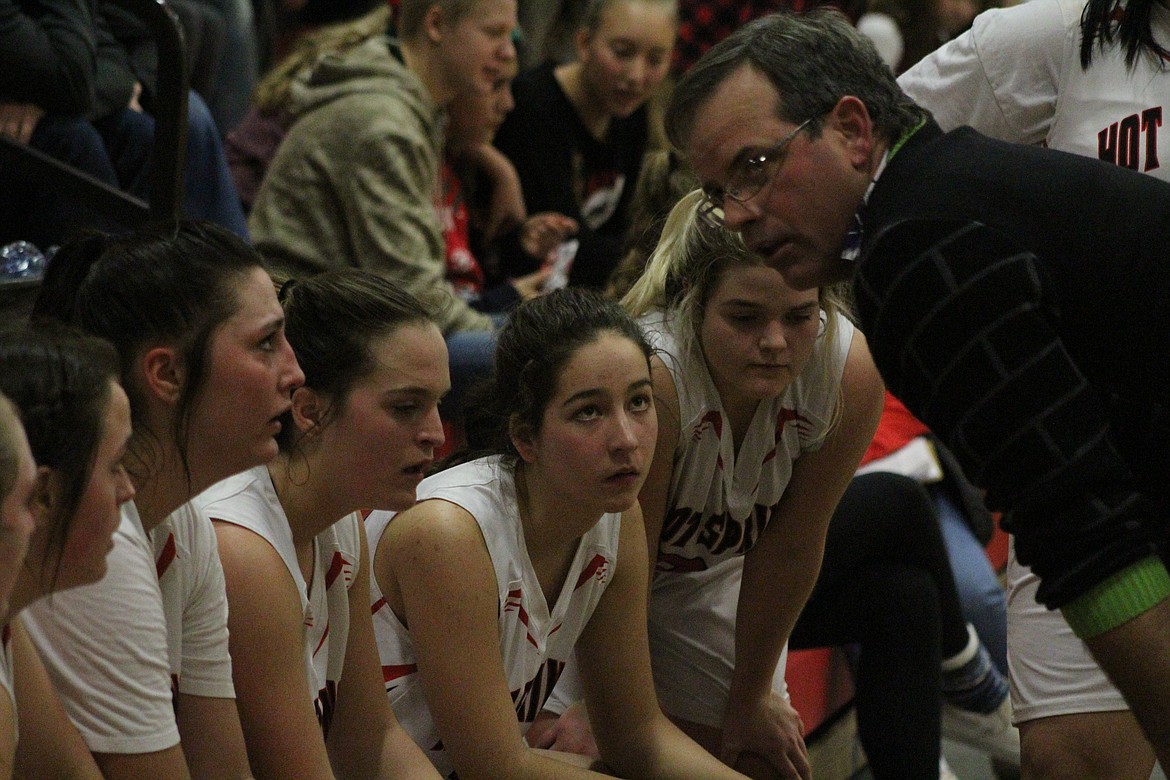 COACH RICHARD Jackson giving his girls the &#147;talk&#148; that rounded them together for a victory against Seeley last Friday night. (John Dowd/Clark Fork Valley Press)