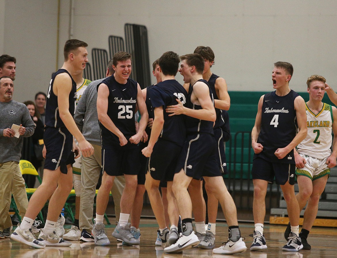 LOREN BENOIT/Press 
Lake City players celebrate Seth Hanson&#146;s (12) key basket in the final seconds of Tuesday night&#146;s game at Lakeland High School.