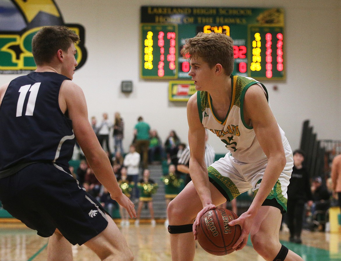 Lakeland&#146;s Noah Haaland ponders a move while defended by Lake City&#146;s Zach Johnson. (LOREN BENOIT/Press)