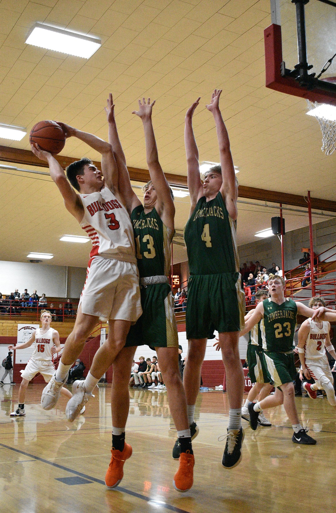 (Photo by DYLAN GREENE)
Senior Christian Niemela attempts to shoot over a pair of St. Maries defenders on Tuesday night.