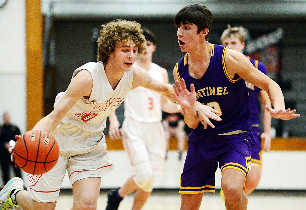 Flathead's Hunter Hickey (10) dribbles around Missoula Sentinel's TJ Rausch (10) at Flathead High School on Thursday. (Casey Kreider/Daily Inter Lake)