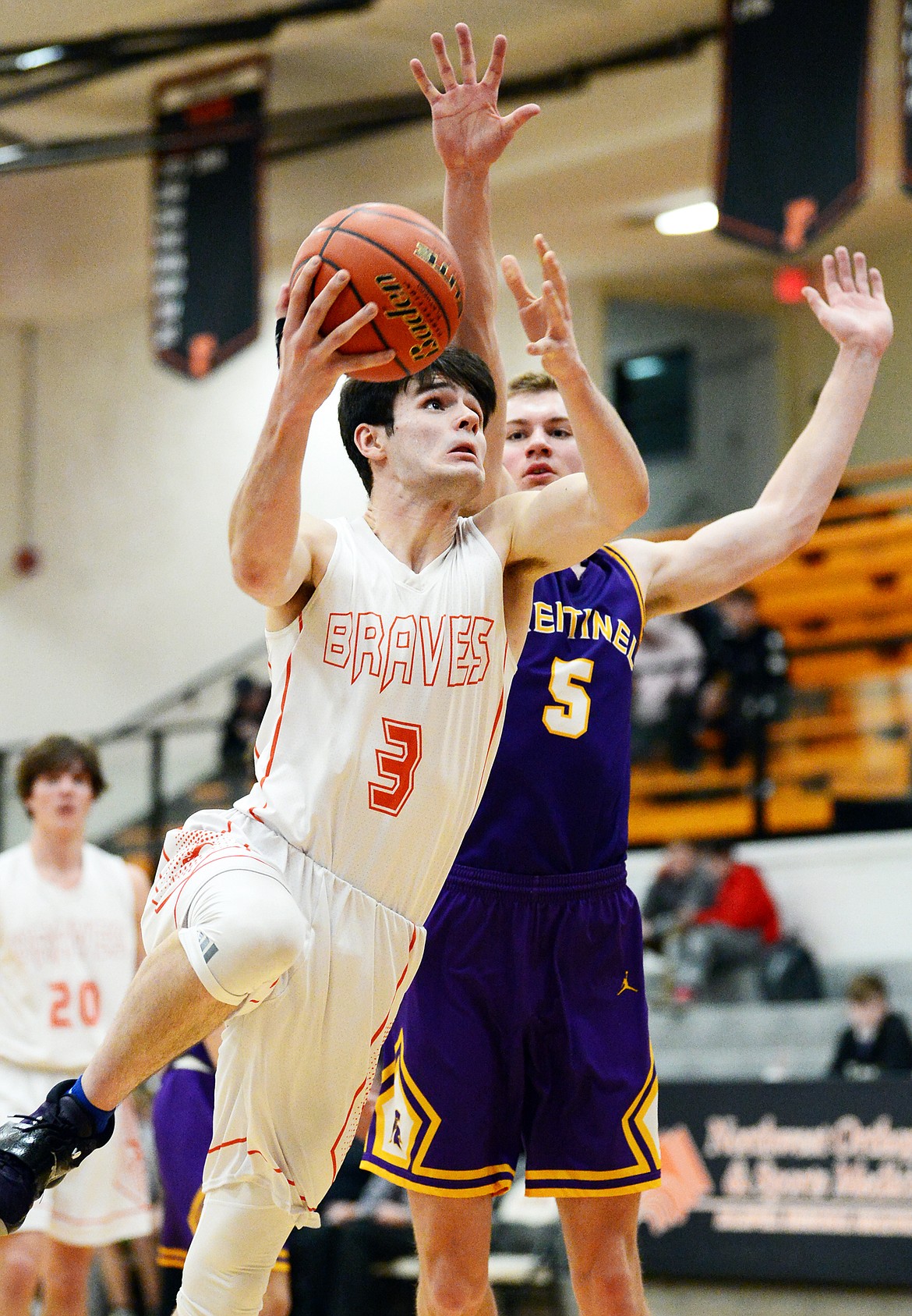 Flathead's Gabe Adams (3) drives to the basket past Missoula Sentinel's Alex Germer (5) at Flathead High School on Thursday. (Casey Kreider/Daily Inter Lake)