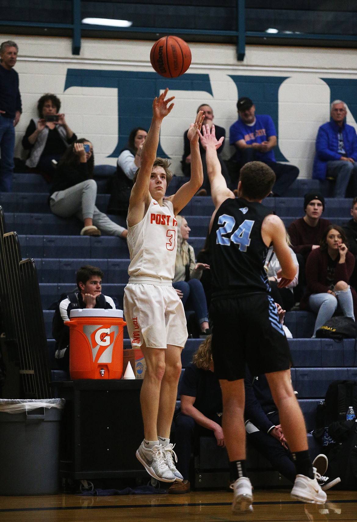 Post Falls Caden McLean shoots a three while defended by Roger Puyallups Nate Hansen in a Lake City Invitational game on Thursday. (LOREN BENOIT/Press)