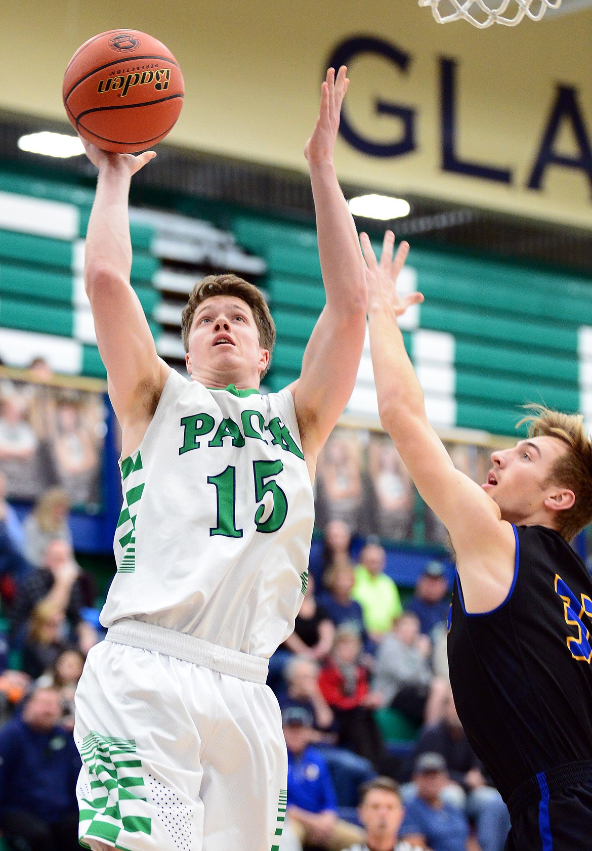 Glacier's Drew Engellant (15) drives to the basket past Missoula Big Sky's Everett Fred (33) at Glacier High School on Tuesday. (Casey Kreider/Daily Inter Lake)