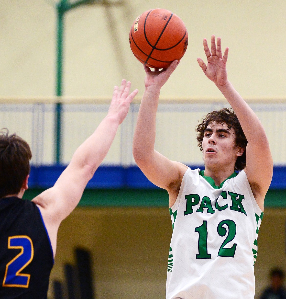 Glacier's Weston Price (12) looks to shoot over Missoula Big Sky's Robert Peterson (42) at Glacier High School on Tuesday. (Casey Kreider/Daily Inter Lake)