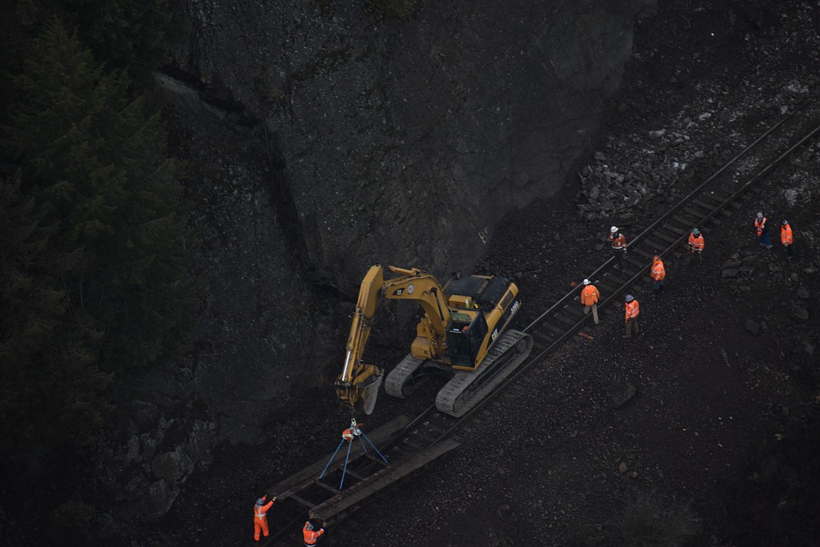 Photo by DYLAN GREENE 
Crews work on repairing the track that reopened last saturday.