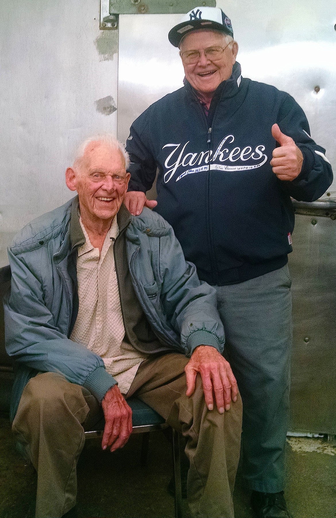 Buddies Don Larsen, left, from Hayden Lake and the only pitcher to throw a no-hitter and perfect game in World Series history, and Post Falls' Lyle Ekness pose at Ekness Catering recently. Ekness is donning a jacket with the autographs of Larsen, David Cone and David Wells, the three Yankee pitchers who have pitched a perfect game. (BRIAN WALKER/Press)