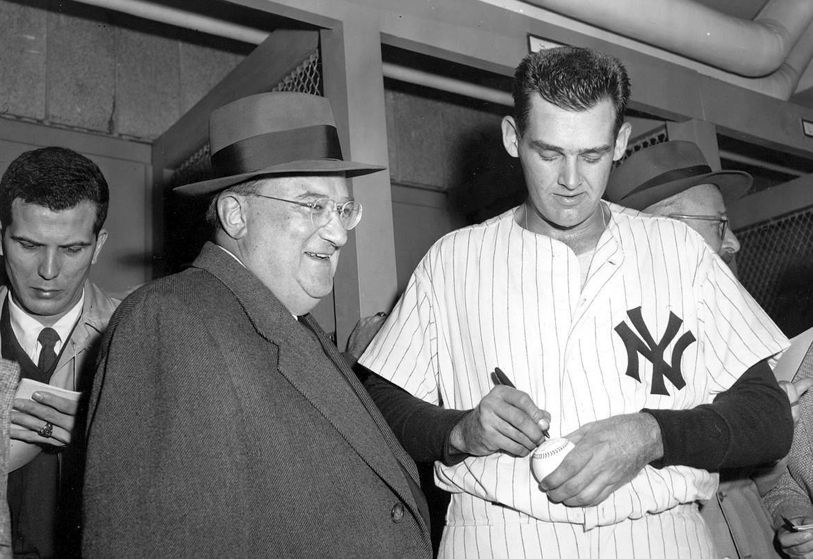 Associated Press file
Don Larsen signs a baseball for Brooklyn Dodgers owner Walter O&#146;Malley in the dressing room after Larsen pitched a perfect game against the Dodgers during Game 5 of the 1956 World Series at Yankee Stadium in New York.