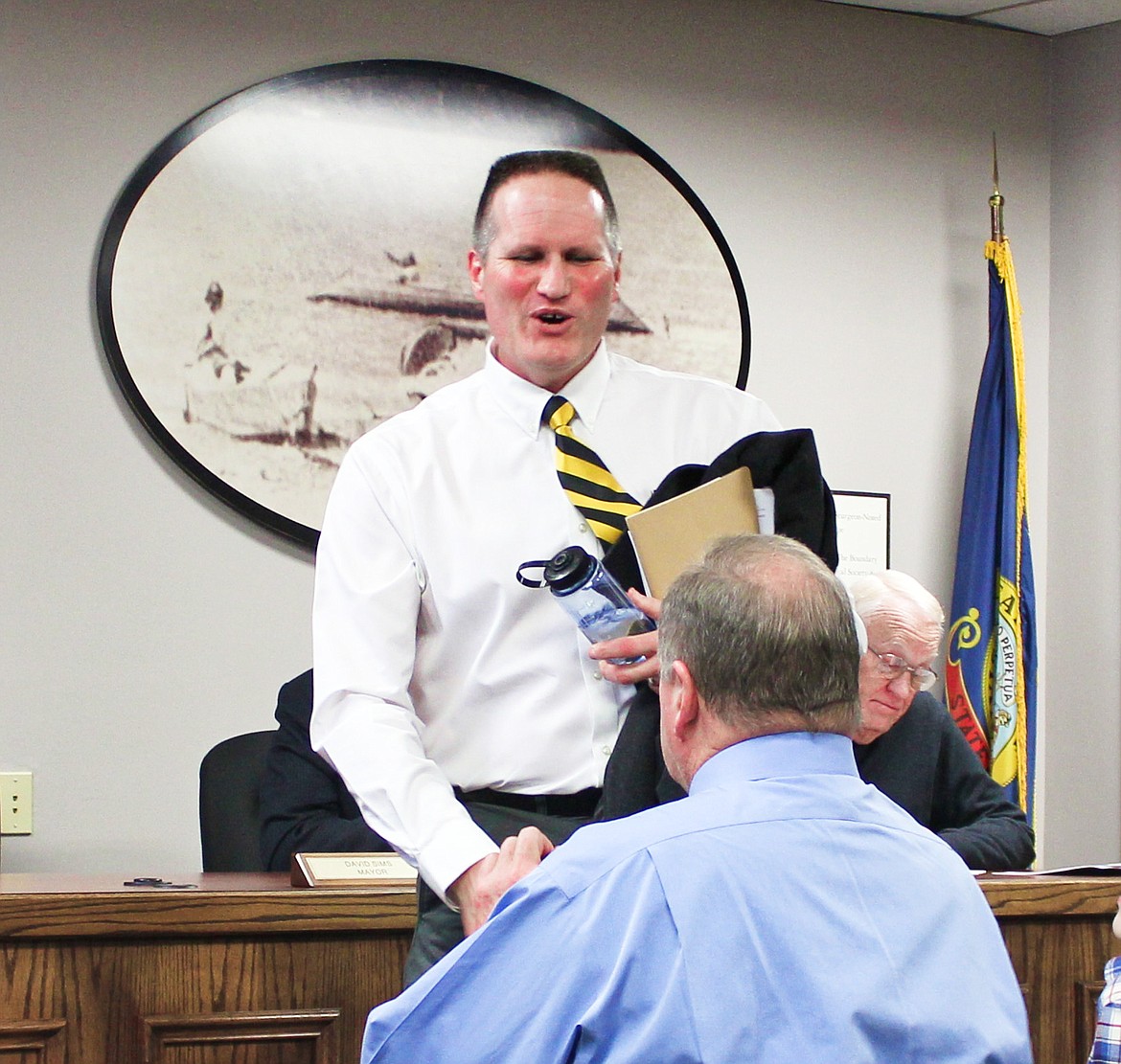 Photo by TONIA BROOKS
During Tuesday evening&#146;s crowded City Council meeting, David Sims steps down and welcomes Dick Staples to the position of Bonners Ferry Mayor.