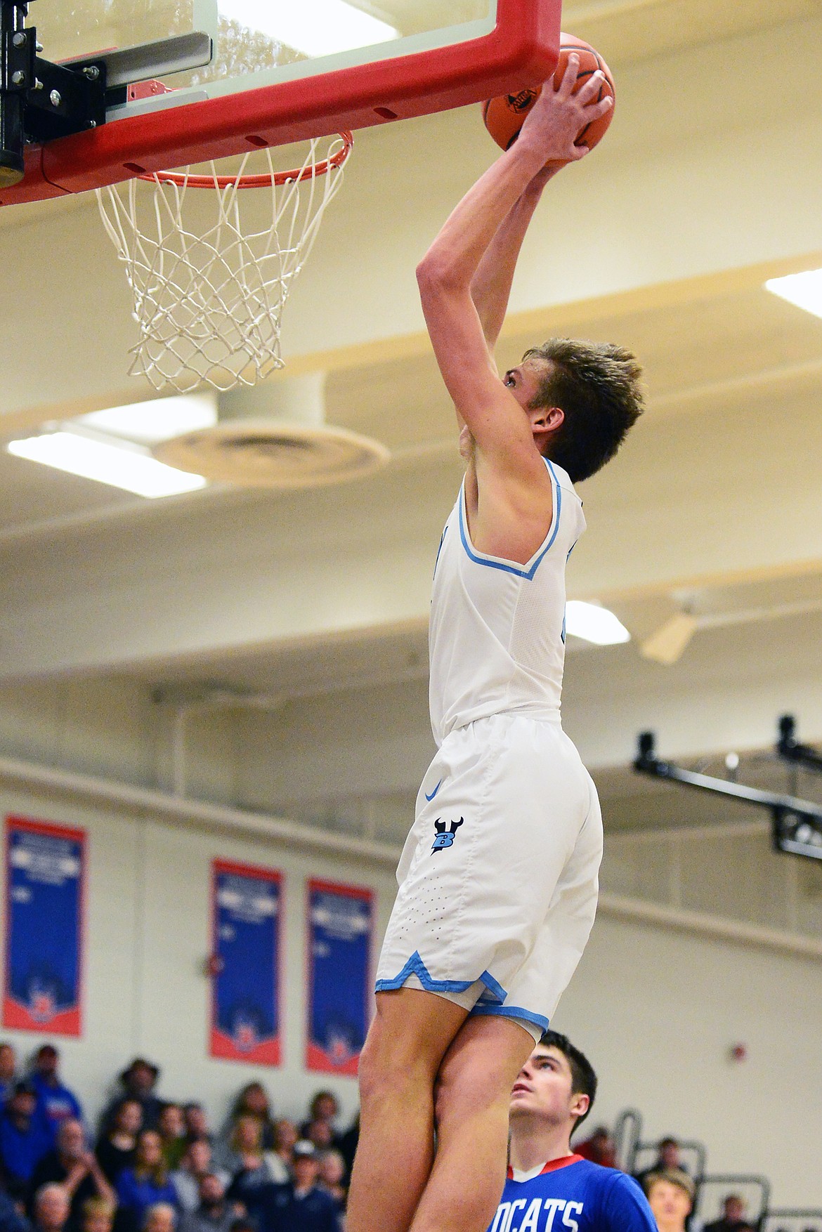 Bigfork's Colt Thorness (1) throws down a two-handed dunk in the second half against Columbia Falls at Bigfork High School on Friday. (Casey Kreider/Daily Inter Lake)