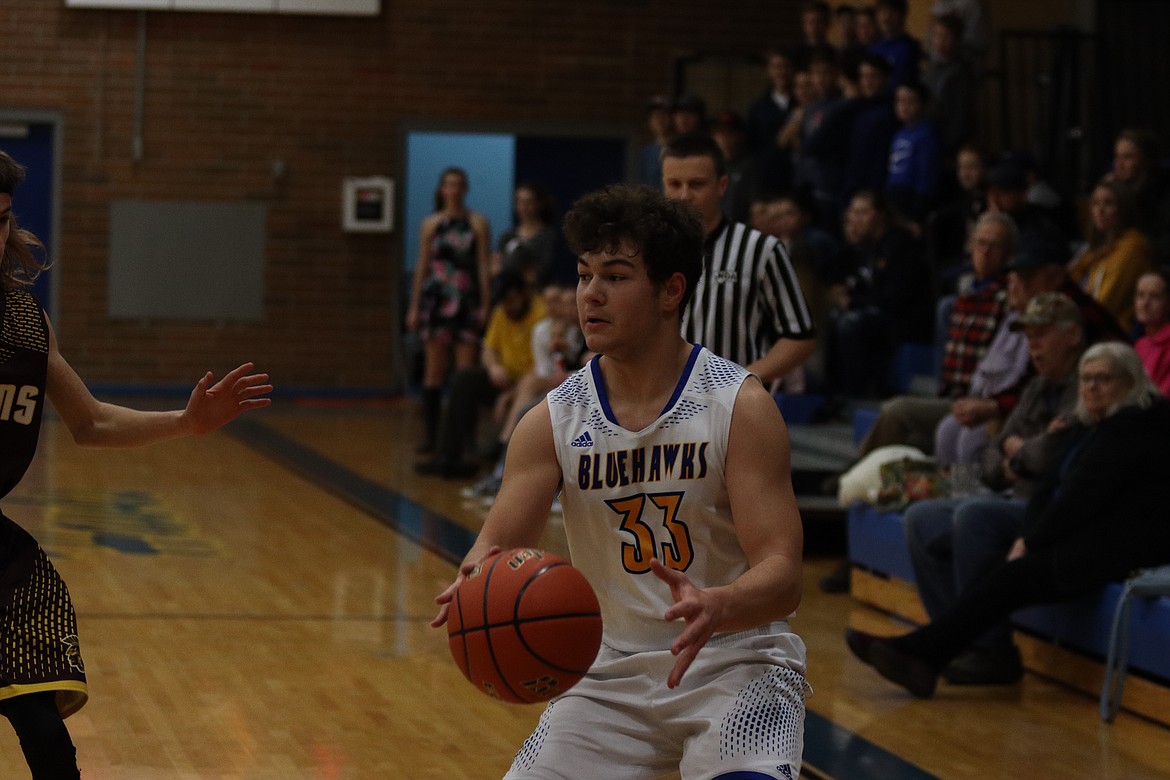 TREY FISHER about to take a 3-point shot for Thompson Falls last Saturday night against Troy. (John Dowd/Clark Fork Valley Press)