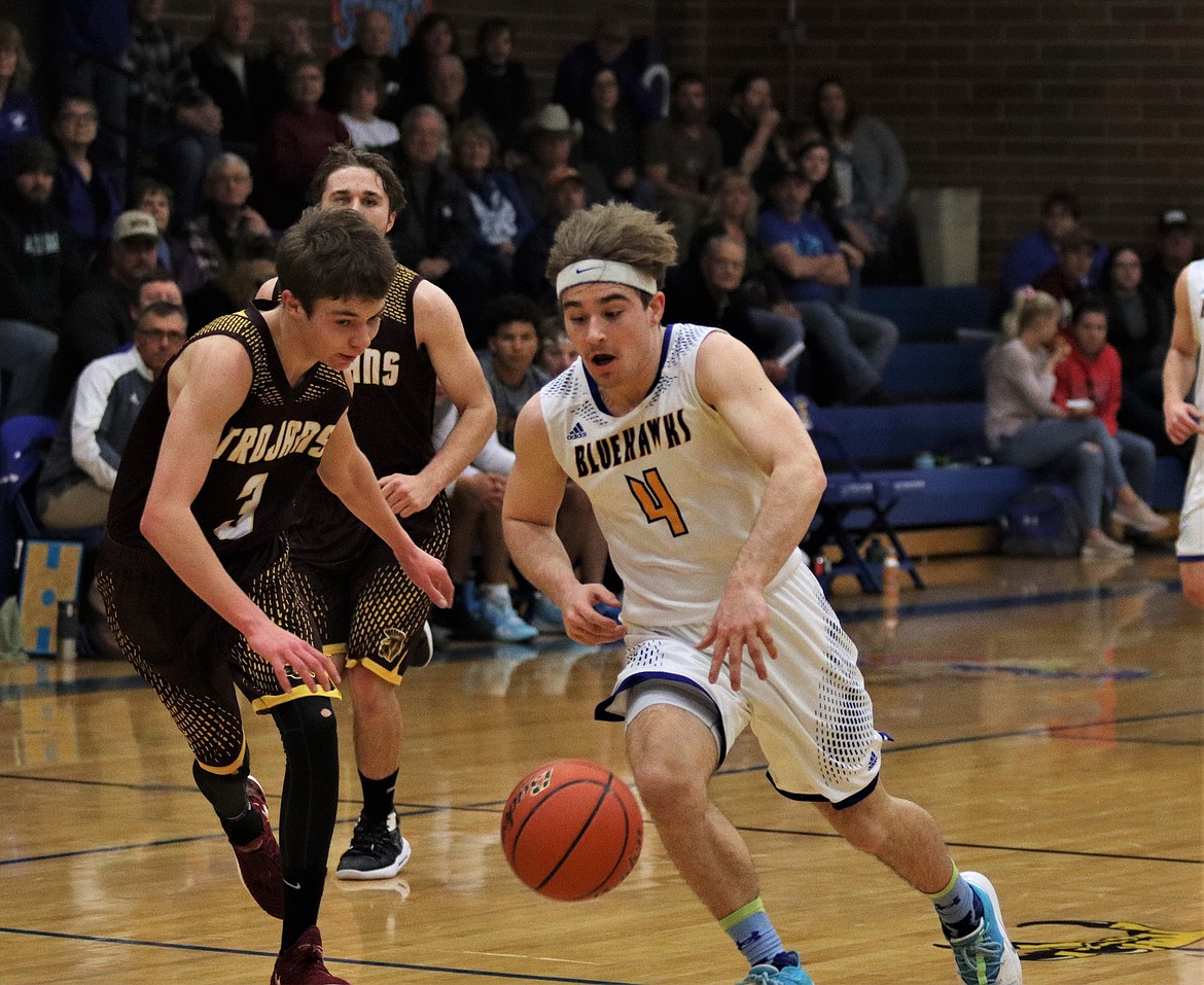 RYAN SCHRAEDER (4) brings the ball upcourt against the Trojans. (John Dowd/Clark Fork Valley Press)