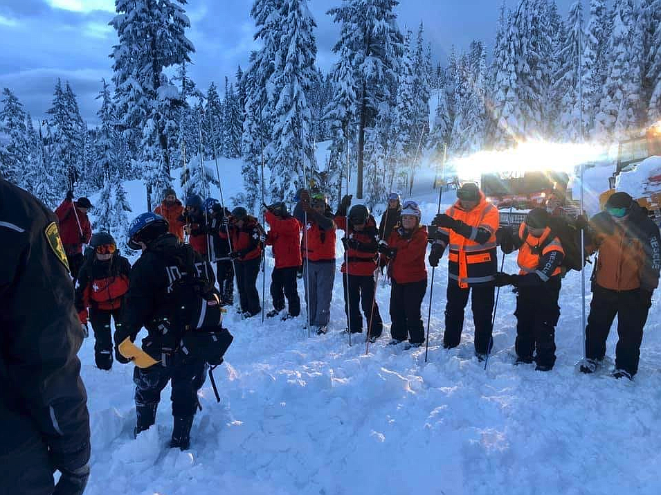 Courtesy photo/Rescue crews use probes to search the Wardner Peak area for the last missing skier on Wednesday.
