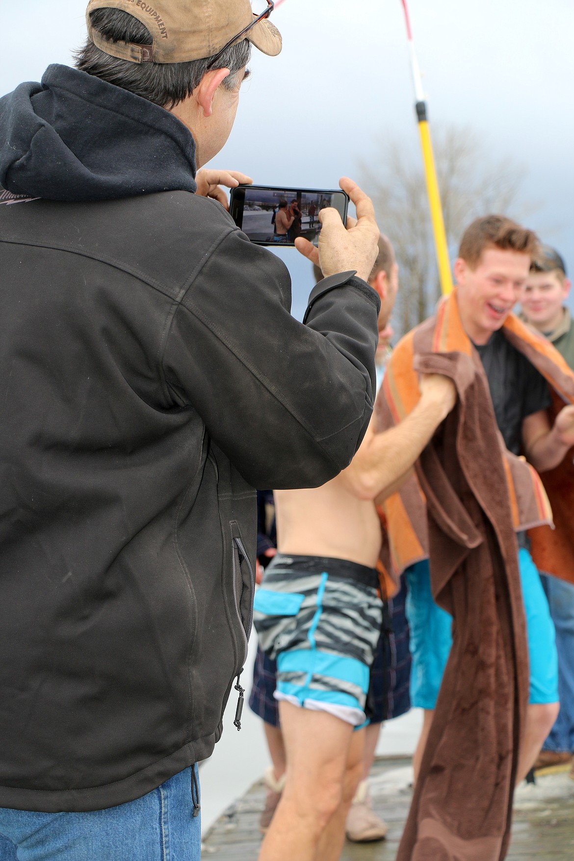 (Photo by CAROLINE LOBSINGER)A resident captures the action on his cellphone during Wednesday&#146;s annual Polar Bear Plunge.