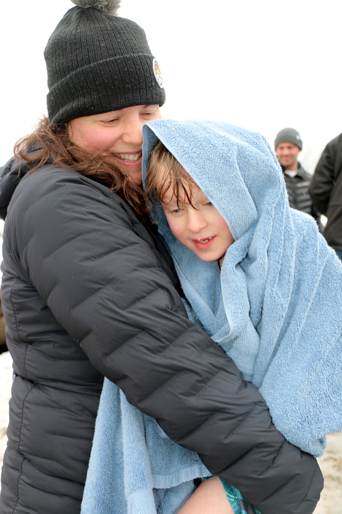 (Photo by CAROLINE LOBSINGER)
A young Polar Bear Plunge participant gets a hug and a warm towel after taking part in Wednesday&#146;s event.