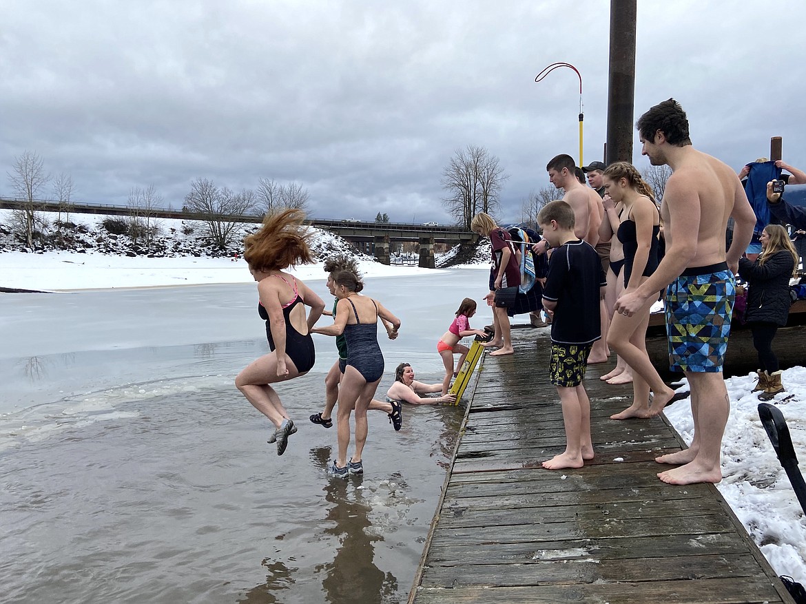 (Photo by CAROLINE LOBSINGER)Participants jump off the dock into a freezing Lake Pend Oreille during the 2020 Polar Bear Plunge on Wednesday.