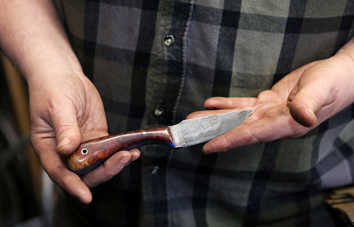 Blacksmith Scott Sweder displays a knife of his creation inside his Columbia Falls forge on Jan. 2.(Mackenzie Reiss/Daily Inter Lake)