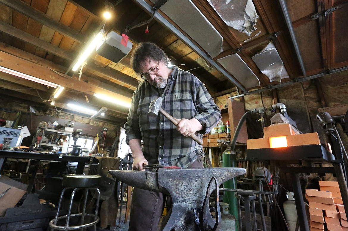 Scott Sweder hammers a blade into shape at his Columbia Falls forge, Iron Bear Knife and Forge, Jan. 2. Sweder will compete in the History Channel&#146;s &#147;Forged in Fire&#148; which will air Jan. 8. (Mackenzie Reiss/Daily Inter Lake)