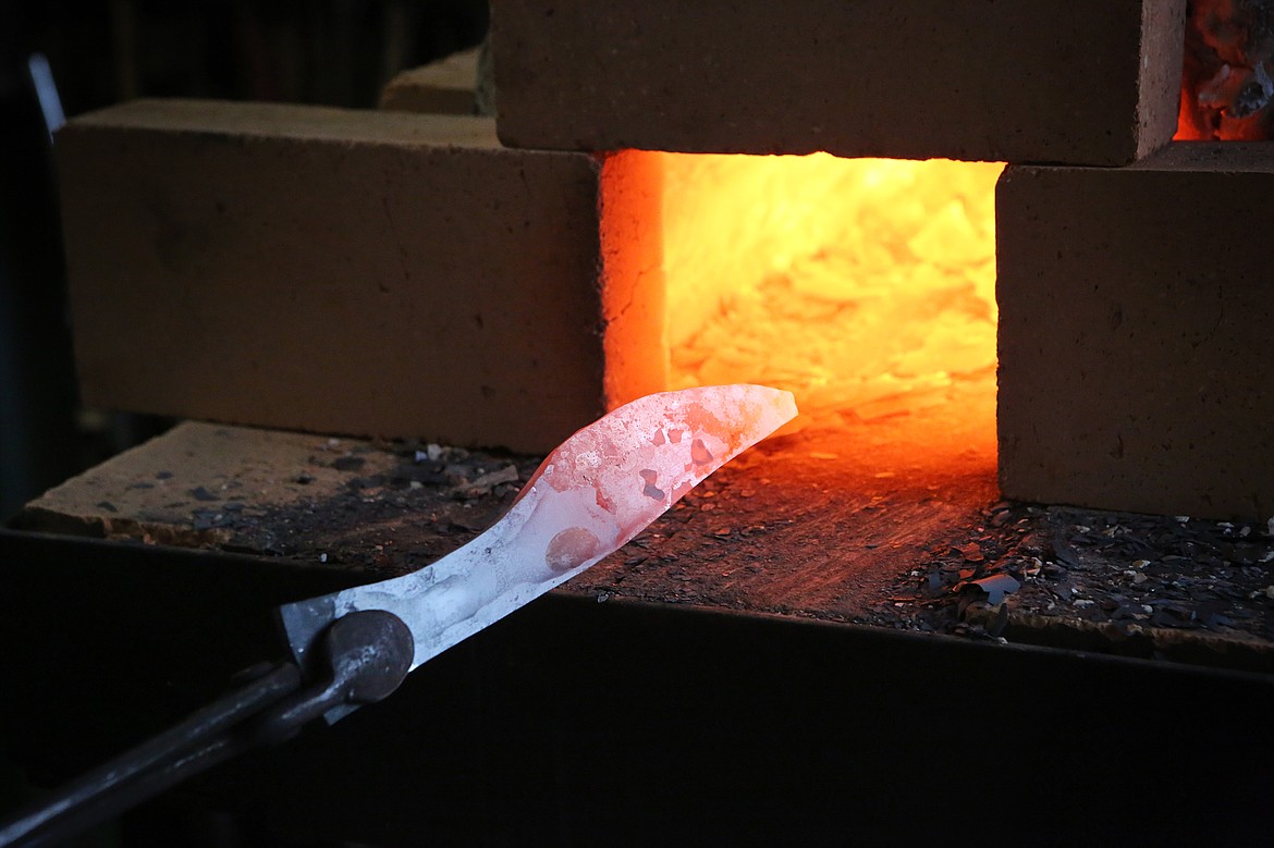 Scott Sweder feeds a blade-in-progress into his forge.