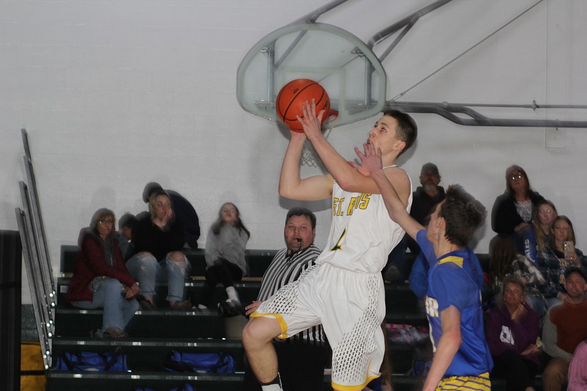 St. Regis high scorer Caleb Ball scores two of his 30 points against Victor in a 76-27 win Saturday. (Chuck Bandel/Mineral Independent)