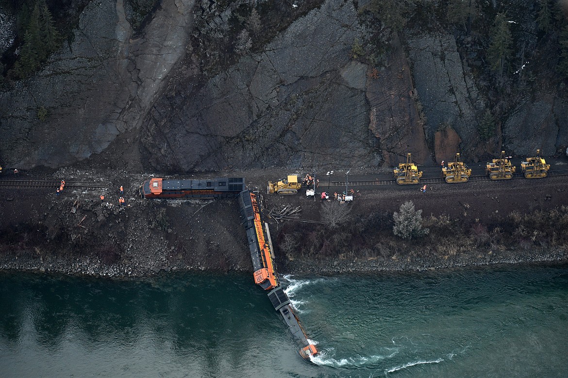 (Photo by DYLAN GREENE)
BNSF crews work to re-rail locomotives knocked off the track by a landslide in Boundary County on Wednesday.