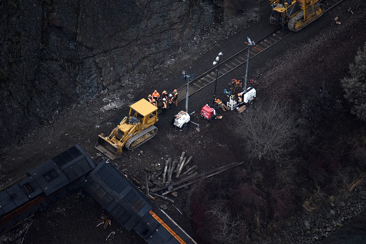 (Photo by DYLAN GREENE)
BNSF crews work to re-rail locomotives knocked off the track by a landslide in Boundary County on Wednesday.