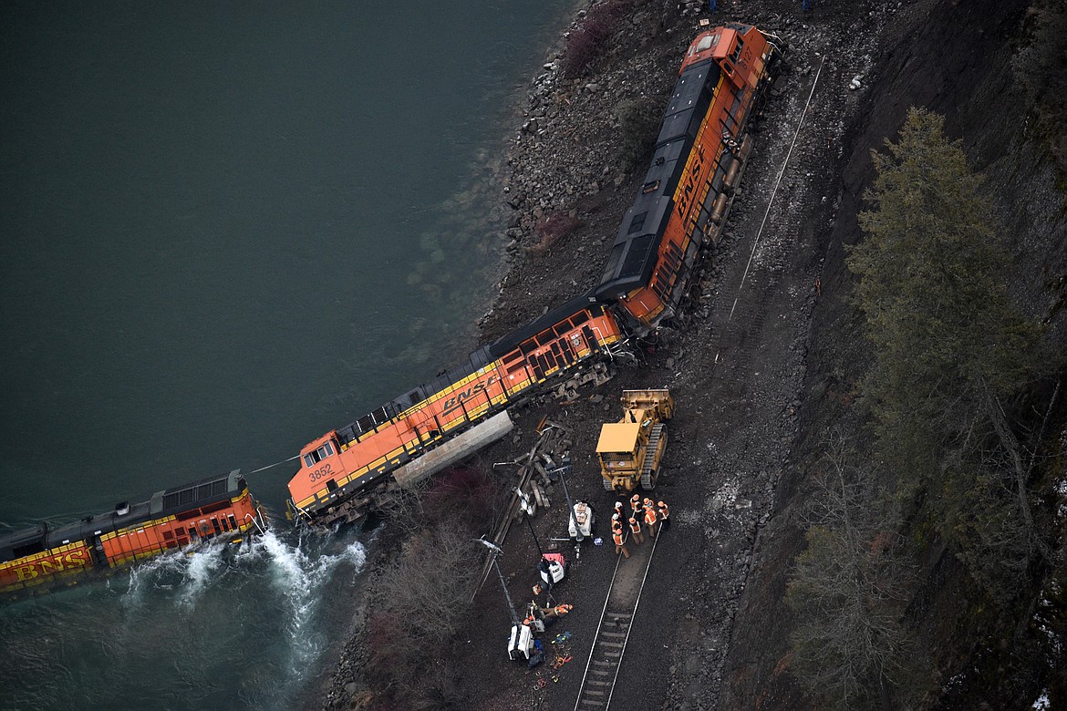 (Photo by DYLAN GREENE)
BNSF crews work to re-rail locomotives knocked off the track by a landslide in Boundary County on Wednesday.