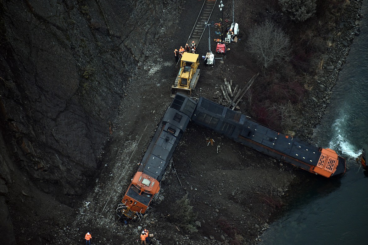 (Photo by DYLAN GREENE)
BNSF crews work to re-rail locomotives knocked off the track by a landslide in Boundary County on Wednesday.