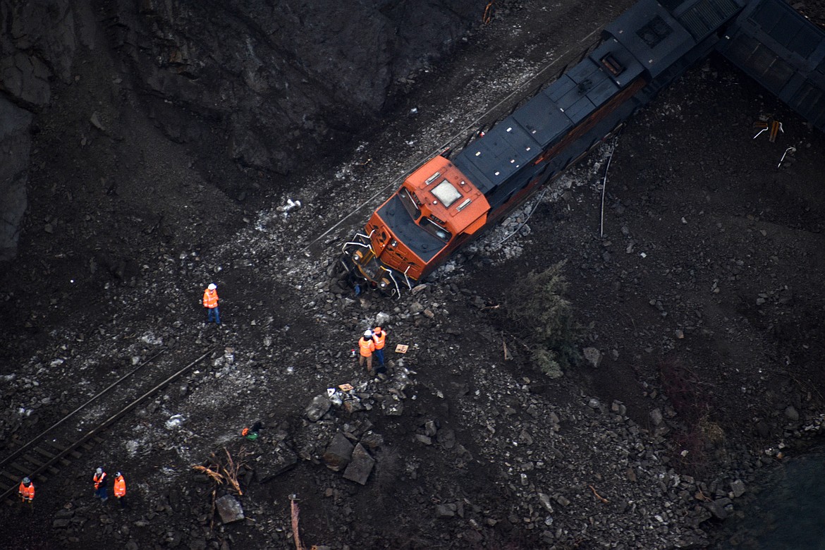 (Photo by DYLAN GREENE)
BNSF crews work to re-rail locomotives knocked off the track by a landslide in Boundary County on Wednesday.