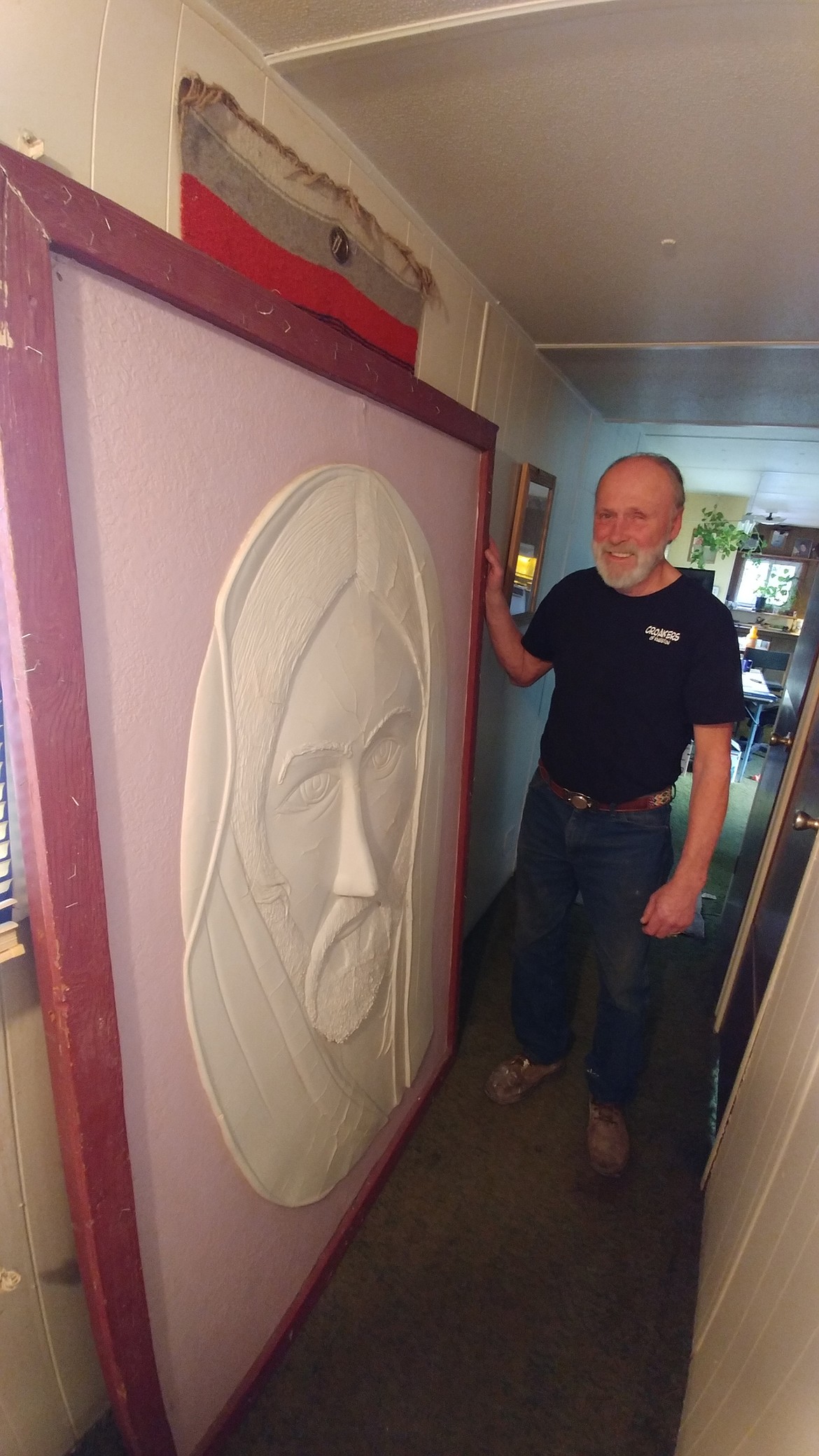 Paradise, Montana artist Darroll Abercrombie displays one of his unique works of art, a mural depicting the face of Jesus, from his home and studio. Abercrombie has created a wide variety of art pieces that are known across the Northwest U.S. (Chuck Bandel/Mineral Independent)