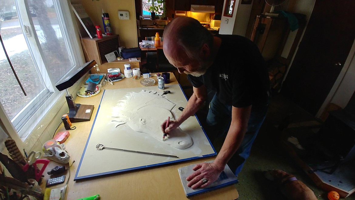 Paradise, Montana artist Darroll Abercrombie works on a piece from his home/studio recently. He lost his left eye in an accident years ago, but it hasn't stopped him from creating a wide variety of art pieces that are known across the Northwest U.S. (Chuck Bandel/Mineral Independent)