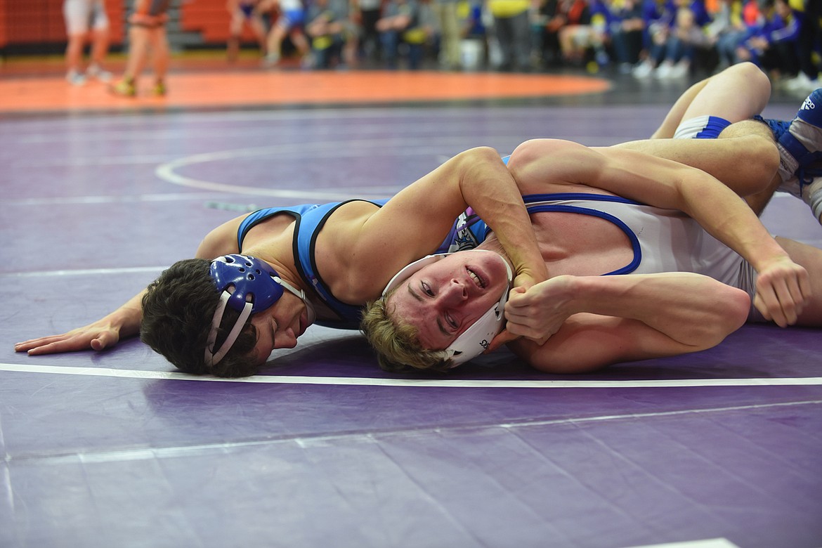 Mission-Charlo&#146;s Isaac Dumontier, left, nearly pinned Townsend&#146;s Ty Owens during their match Jan. 4 at 145 pounds at the Western Duals in Ronan. Dumontier scored a 15-0 win. (Scott Shindledecker/Lake County Leader)