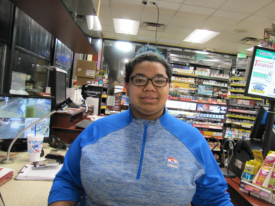 Denisse Rucker-Rodriguez, at the counter of Holiday convenience store at Prairie Avenue and U.S. Highway 95, doesn&#146;t mind working Christmas Day. (Photos/ERICKSON)