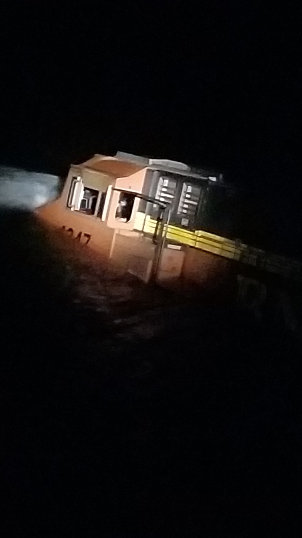 (Courtesy photo)A BNSF Railway engine sits half-submerged in the Kootenai River after derailing late Wednesday night.