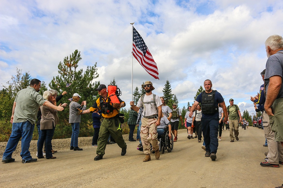 Photo by MANDI BATEMAN
The marchers return from their six mile ruck-march, symbolizing the weight that the veterans have to carry after returning home, during the Carry The Fallen event that took place on Sept. 21.