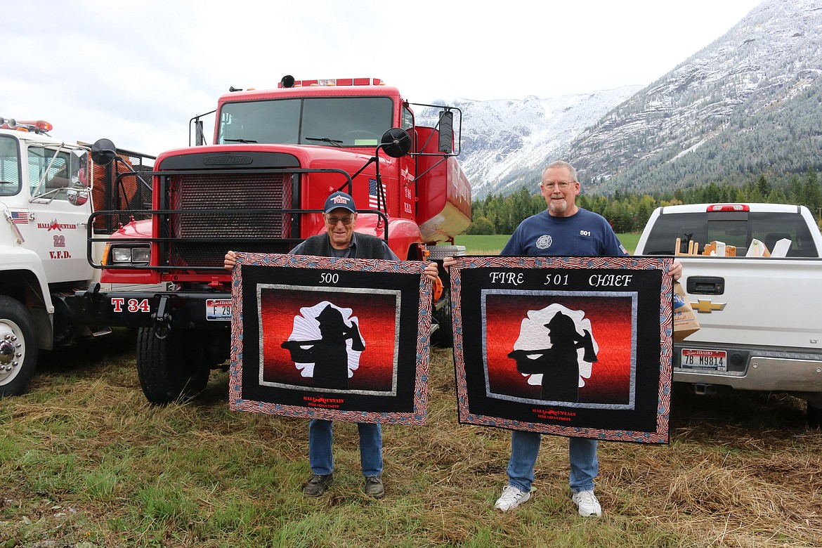 Photo by MANDI BATEMAN
Hall Mountain Assistant Chief Bill Branson and Hall Mountain Fire Chief Brad Lowther with their quilts, presented by the HMVFA Ladies Auxiliary during the Sept. 28 appreciation potluck dinner.